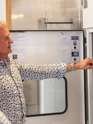 Les Tomlin, President & Co-Founder of PizzaForno showcasing their automated pizza vending machine to a client.