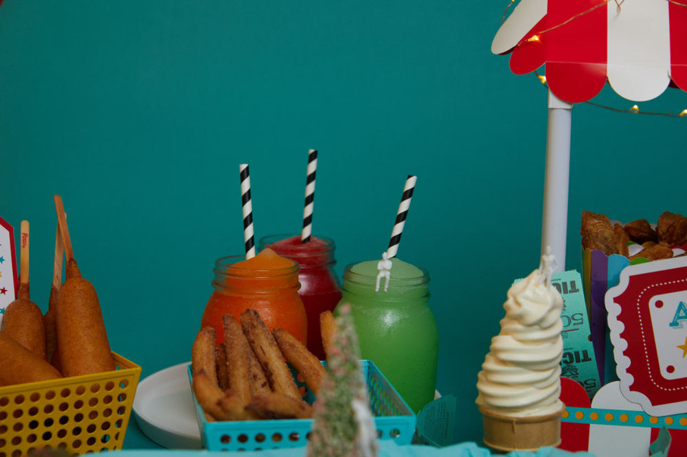 Assorted appetizers including glazed chicken wings, buffalo chicken tacos, cheese sticks, croquettes, and veggie sides, served on white platters with dipping sauces made with commercial food equipment.