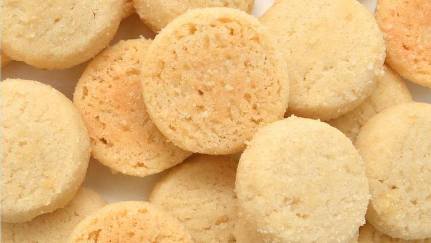 cannabis infused sugar cookies piled on top of each other on a white surface