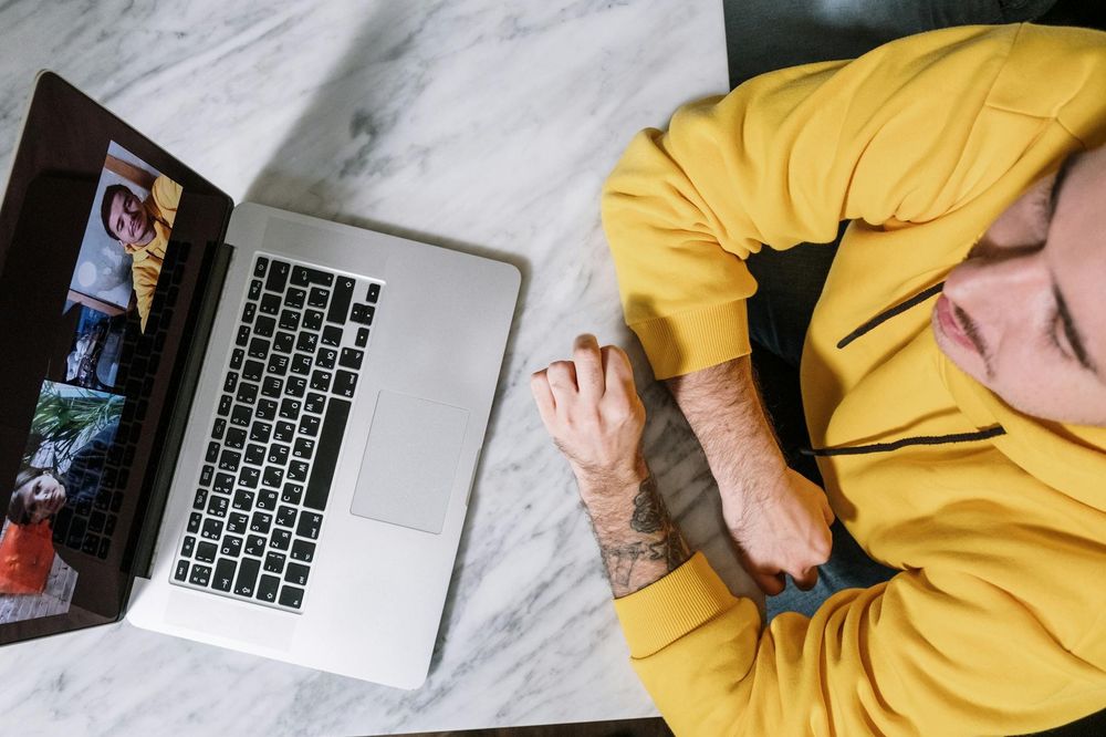 Job seeker browsing job listings on a laptop at a marble table