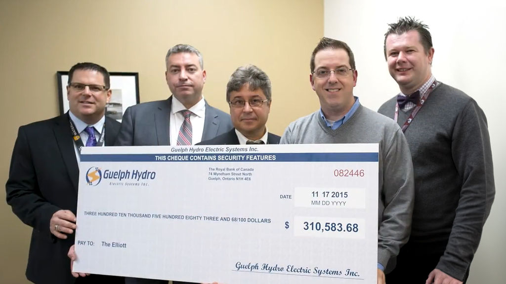 Guelph Hydro Electric Systems presenting a $310,583.68 cheque to The Elliott Community in Guelph, Ontario