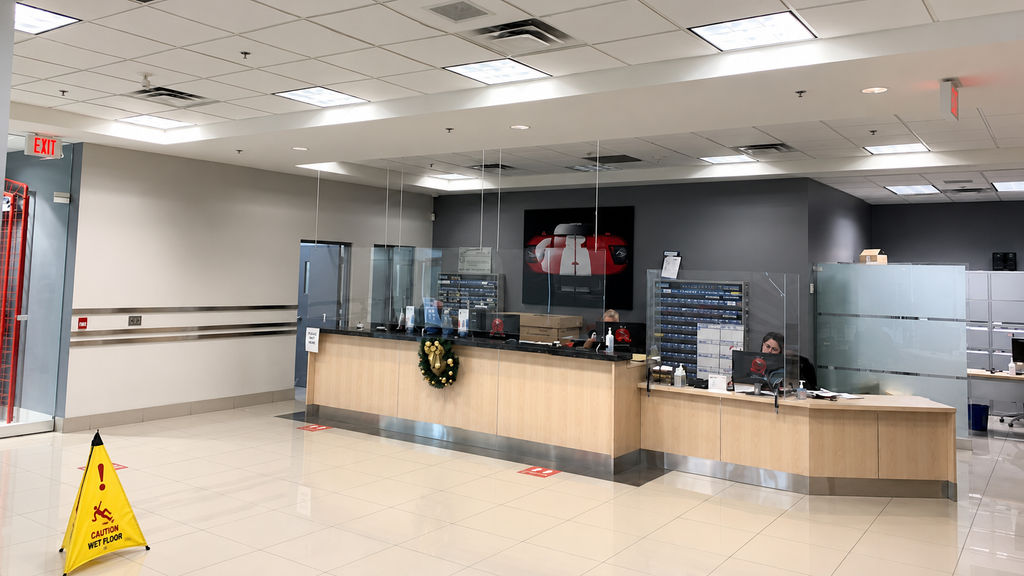 Car dealership service counter with dated overhead panel lighting