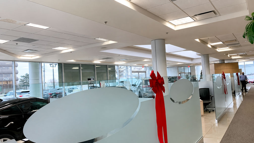 Car dealership showroom with dated overhead panel lighting