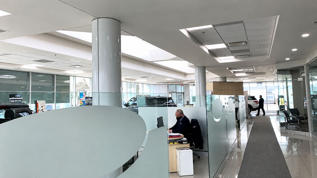 Car dealership showroom illuminated by upgraded LED lighting