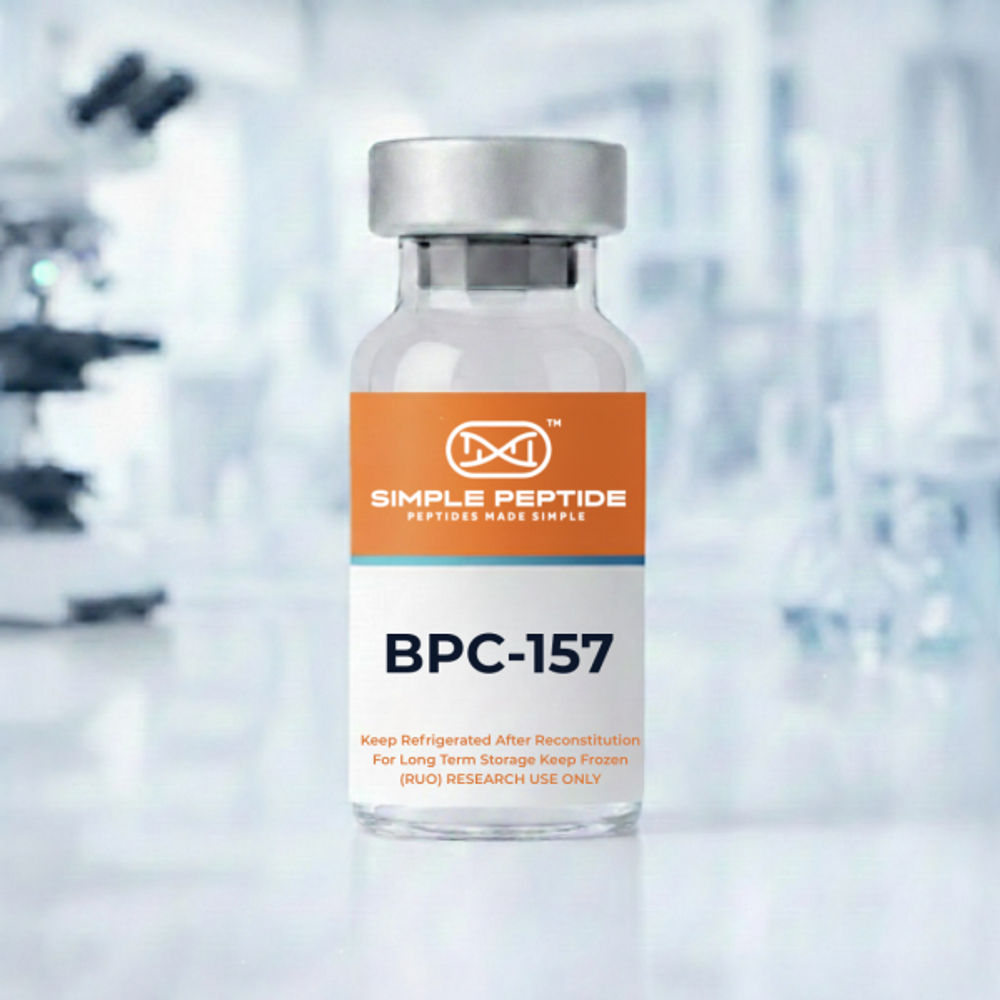A clear glass vial labeled "BPC-157" from Simple Peptide, featuring an orange and white design. The label includes instructions to refrigerate after reconstitution and notes that it is for research use only. The background appears blurred, suggesting a laboratory setting.