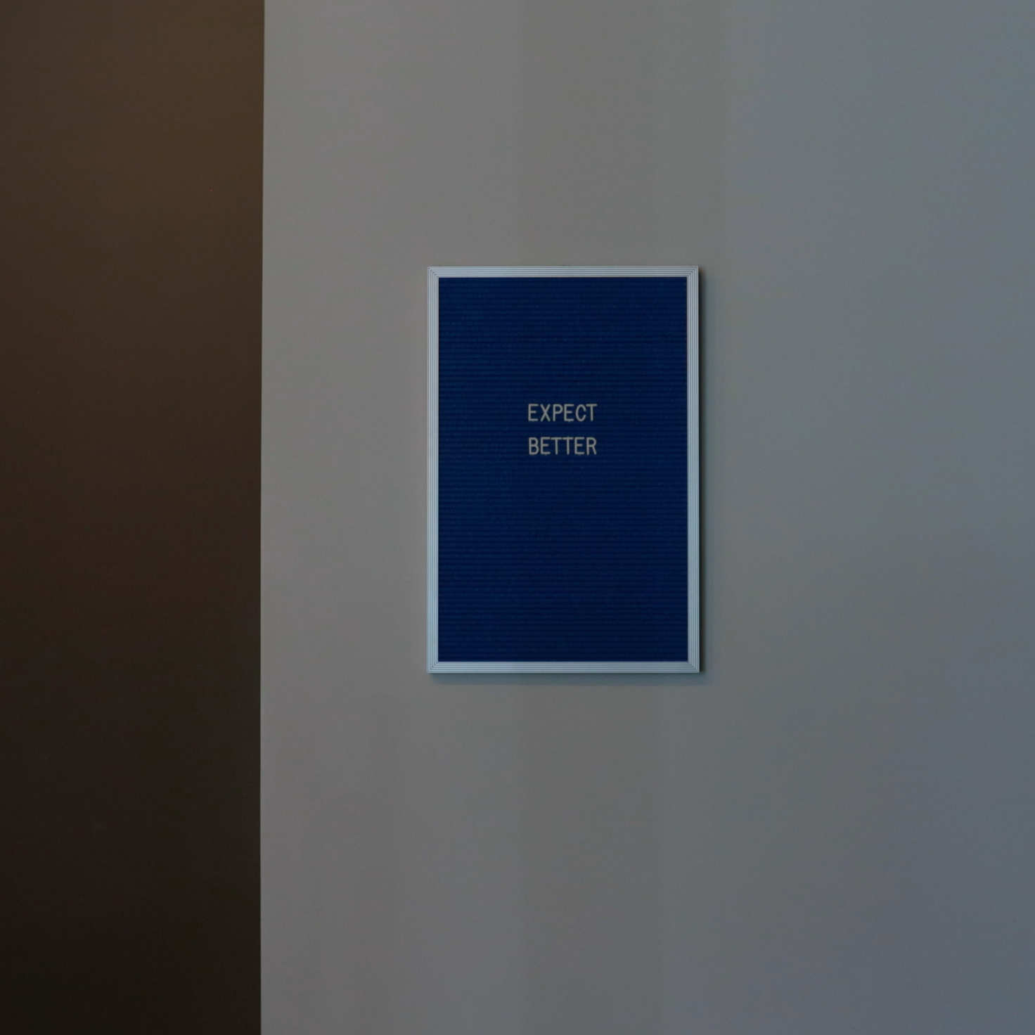 A framed letterboard on Cuttlesoft's office wall reads 'EXPECT BETTER', reflecting our philosophy towards UI/UX design and user experience. This simple but powerful message represents our commitment to exceeding expectations in interface design, from initial wireframes to final implementation. The minimalist presentation against a clean wall mirrors our design approach - clear, purposeful, and focused on what matters. This guiding principle shapes how we approach user research, interface design, and usability testing across web, mobile, and enterprise applications.