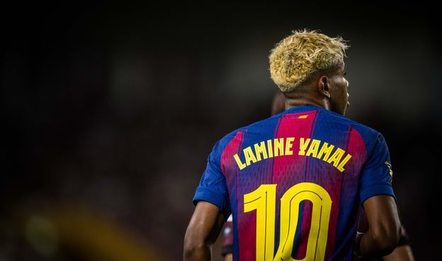 Fc barcelona players celebrating a goal on the field during a match