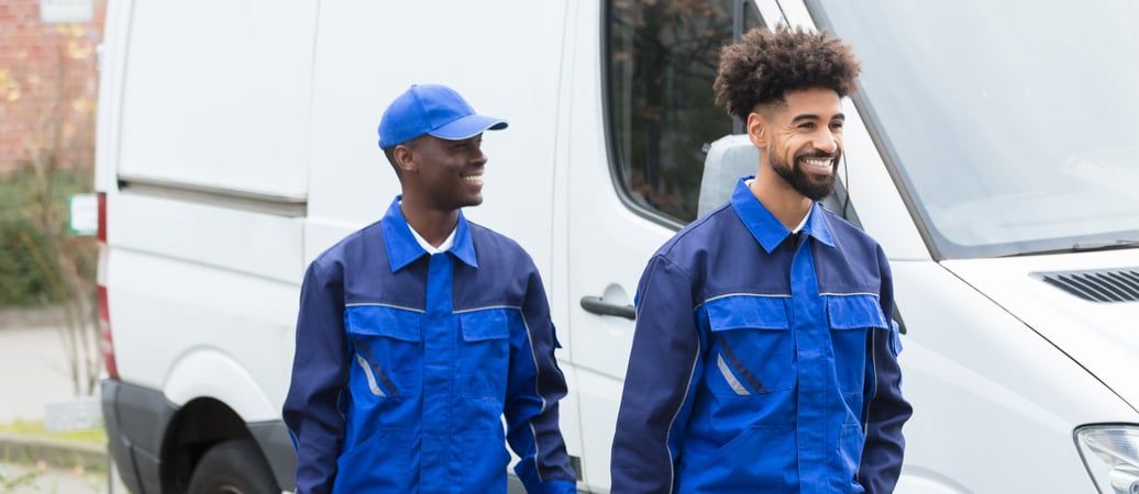 Worker using tablet device in industrial setting with machinery in