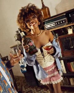 woman holding Havana club bottle and cocktail