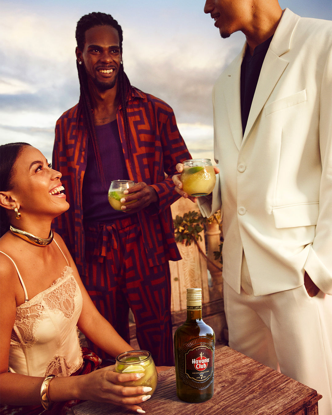 woman and friends sitting with havana club 7 cocktail