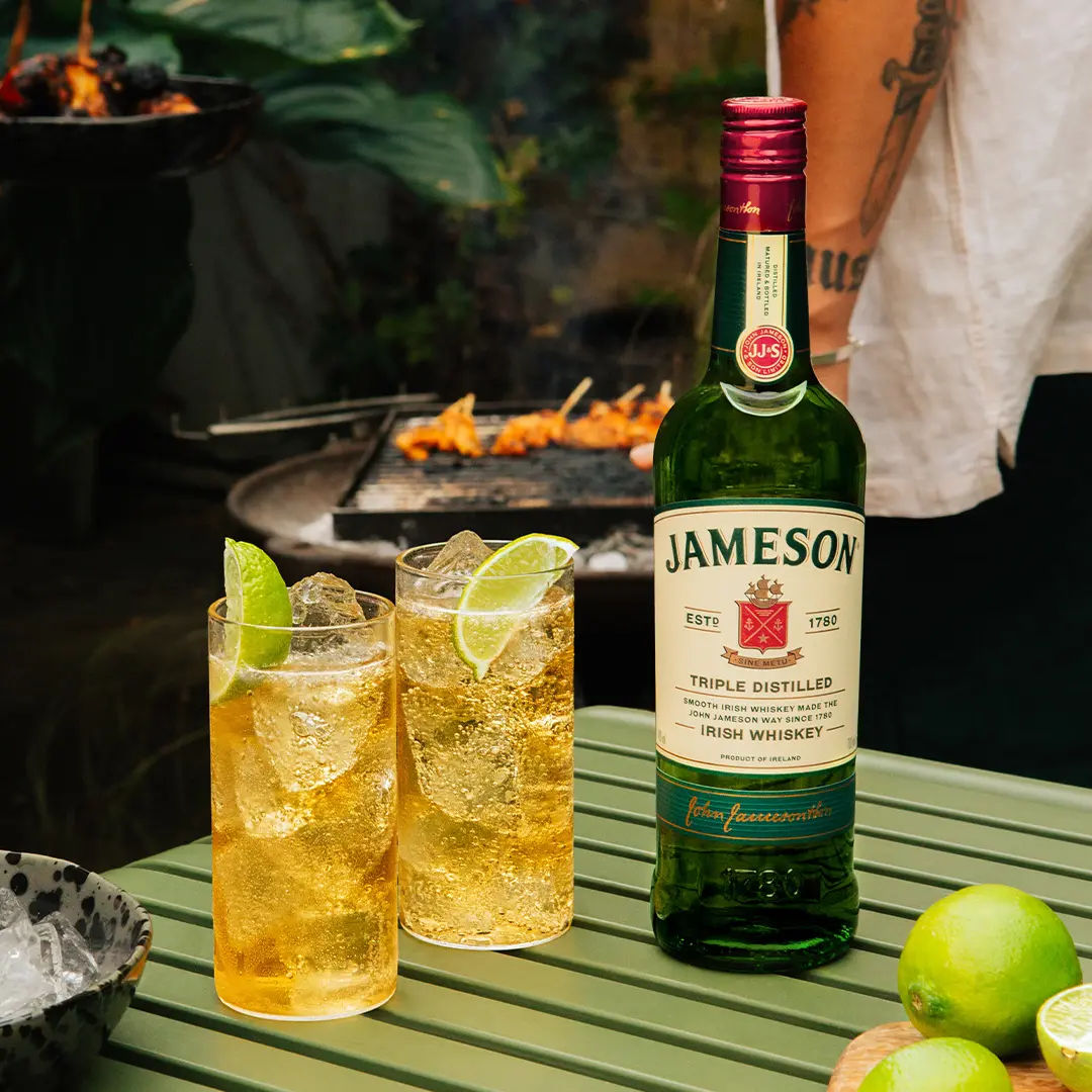 2 glasses of Jameson, ginger & lime whiskey cocktail with Jameson Original bottle