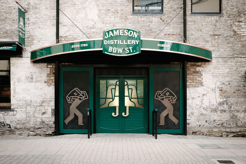 Entrance to Jameson Distillery Bow St. in Dublin with green doors and signage.