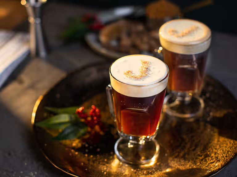 Irish coffee cocktails in whiskey glass mugs