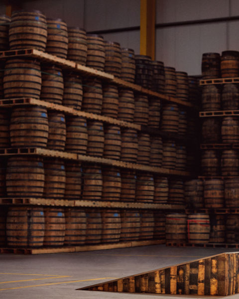 Rows of whiskey barrels to illustrate the third ingredient of whiskey: time