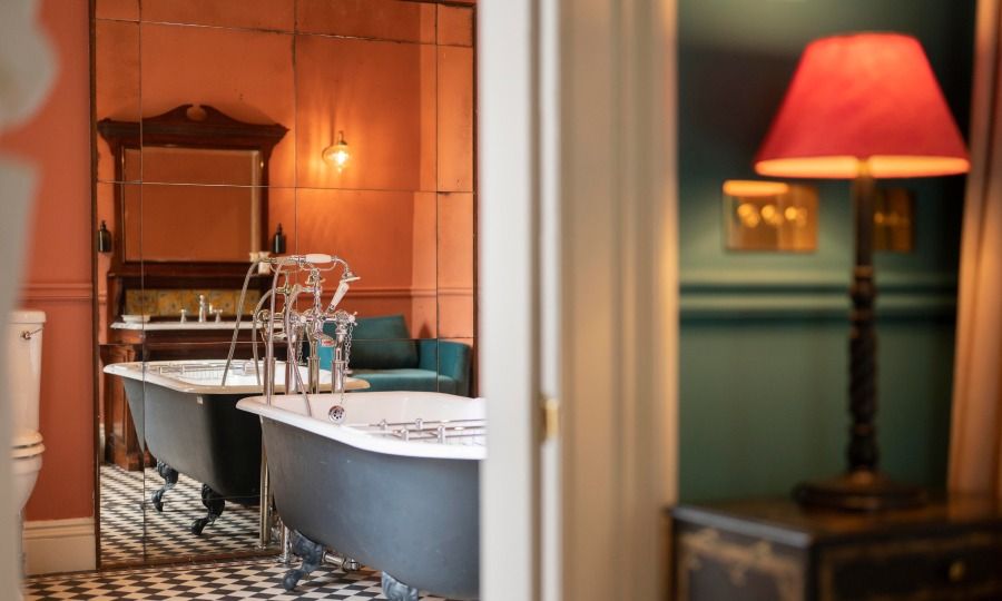 Elegant bedroom at Linn House with luxurious decor, plush bedding, and ambient lighting, offering a serene and comfortable retreat. Ideal for a relaxing stay.