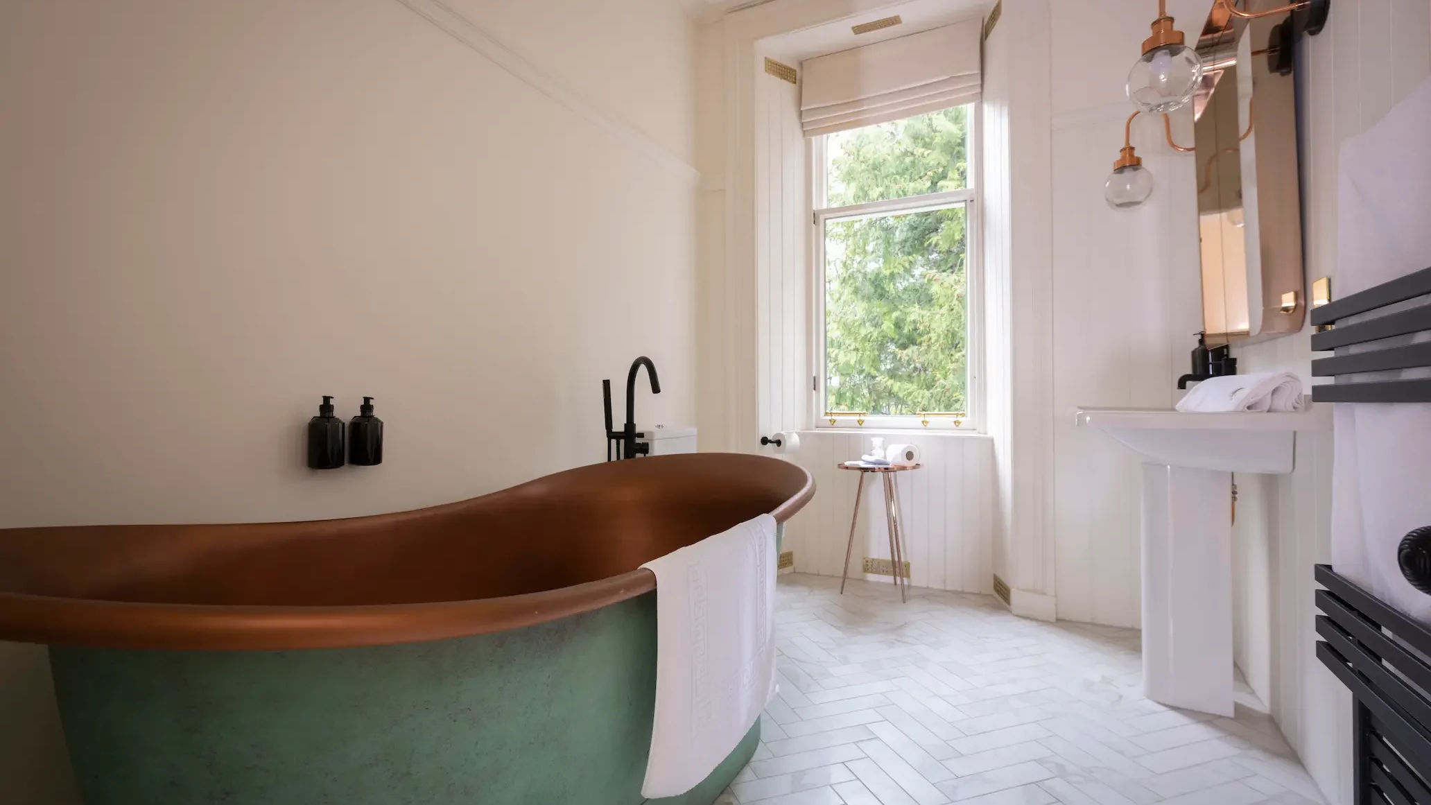 Luxurious modern bathroom with a freestanding bathtub, sleek fixtures, and stylish decor.
