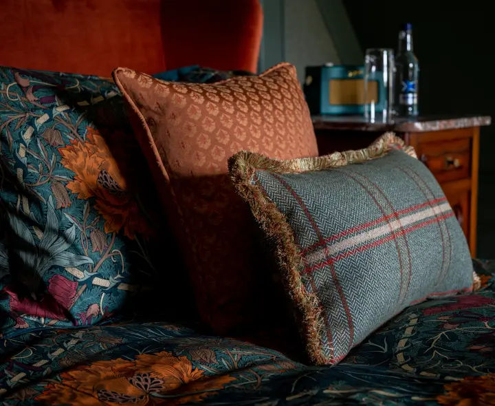 Close-up of plush patterned cushions in the Glenkeith bedroom.