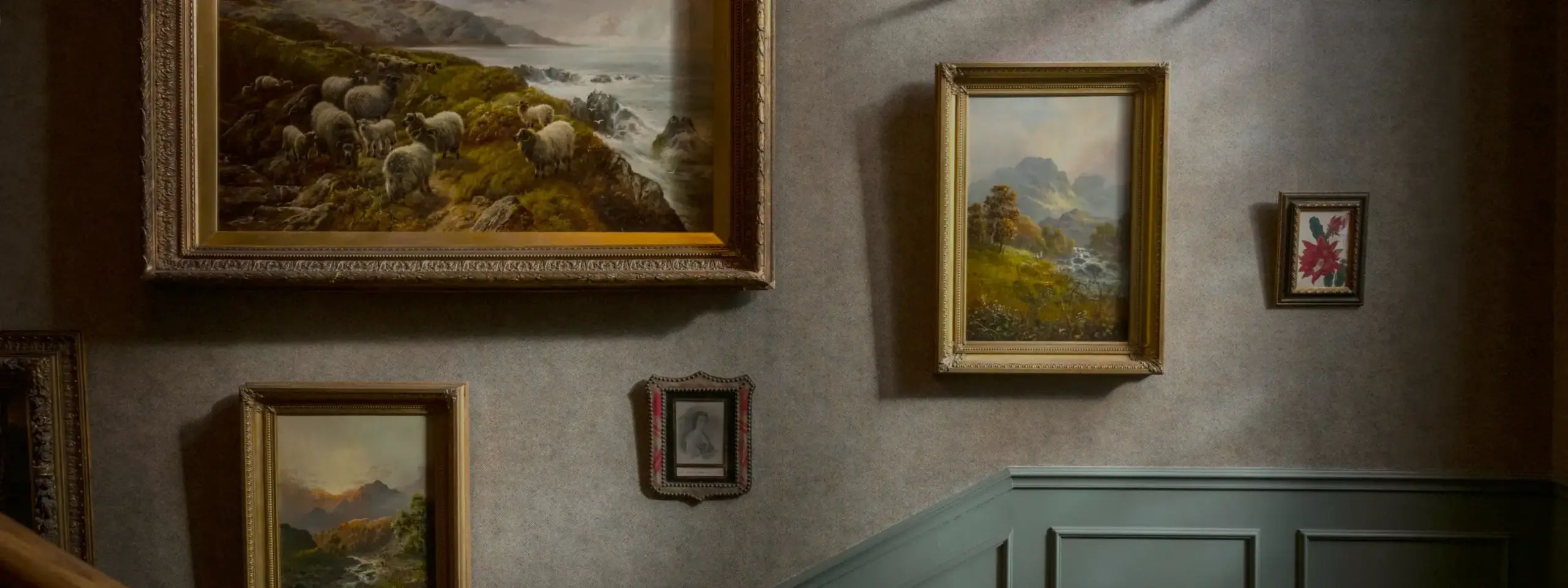 Elegant interior staircase of Linn House featuring beautiful paintings.
