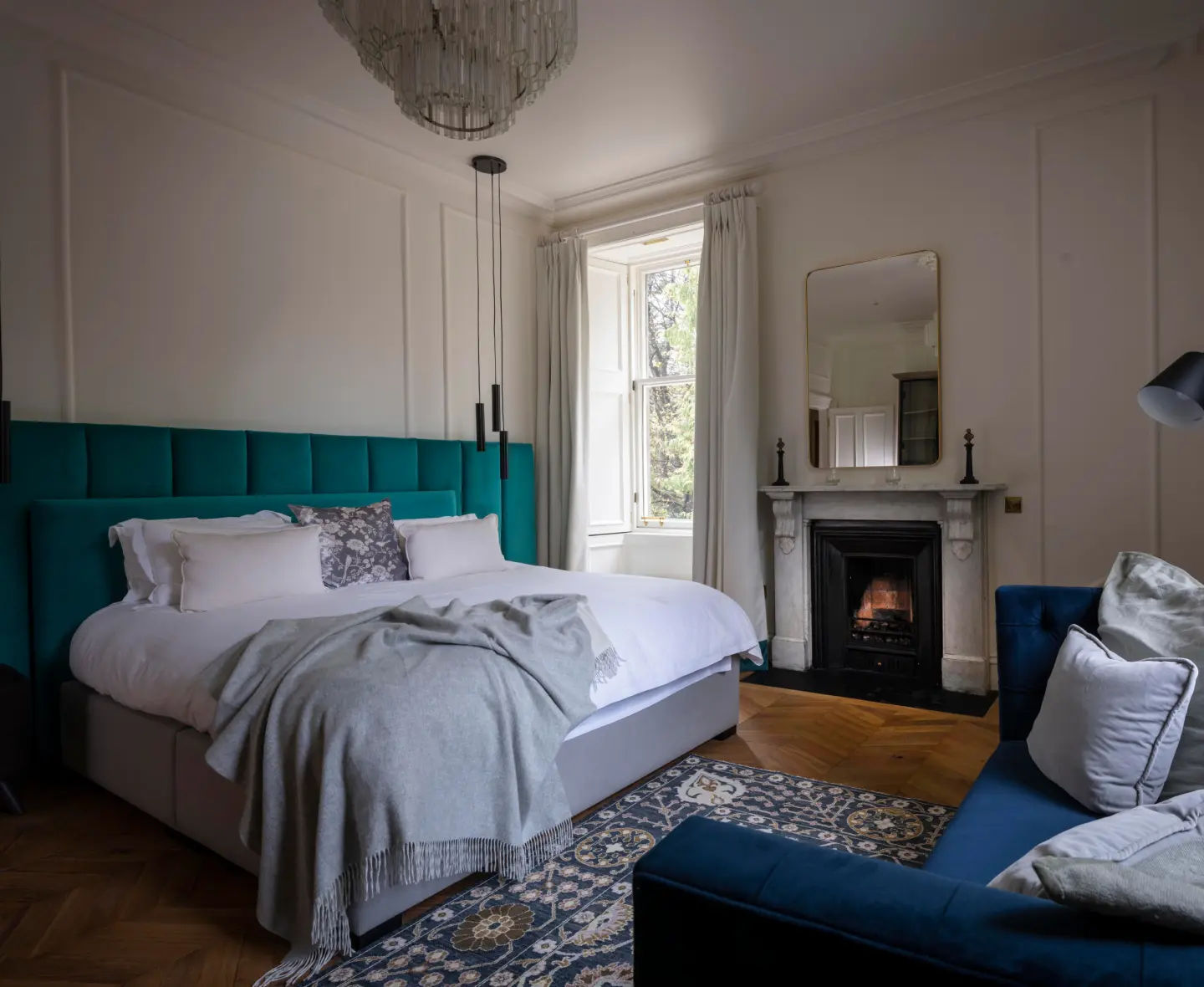 Elegant bedroom at the Glenlivet, featuring a comfortable bed, sophisticated decor, and soft lighting.