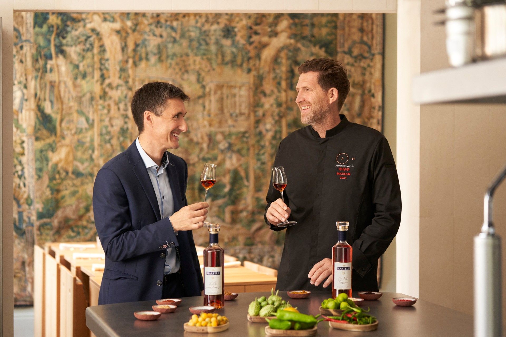 Alexandre Mazzia and Christophe Valtaud with a glass of cognac in hand