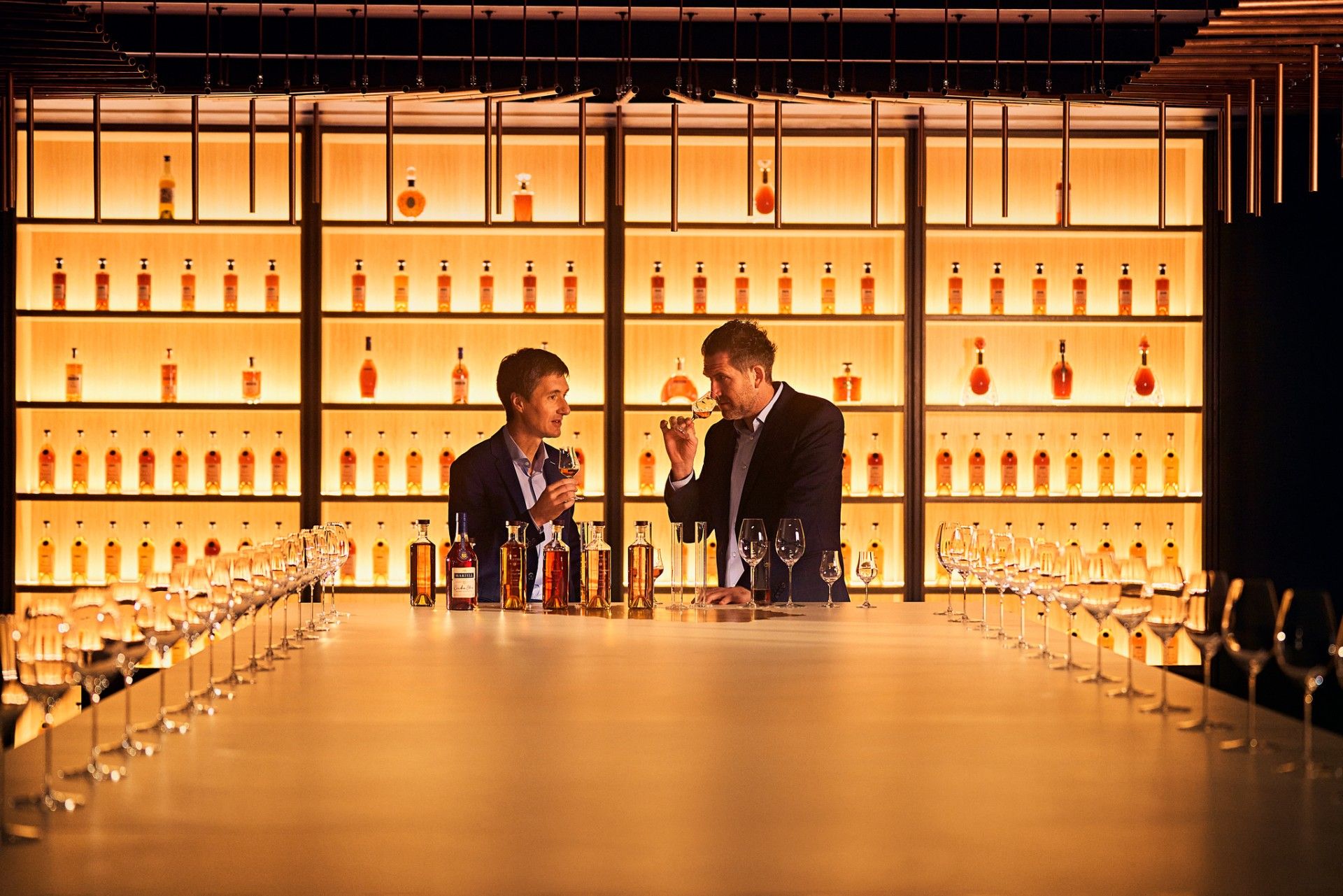 Alexandre Mazzia and Christophe Valtaud smelling Cognac in a glass
