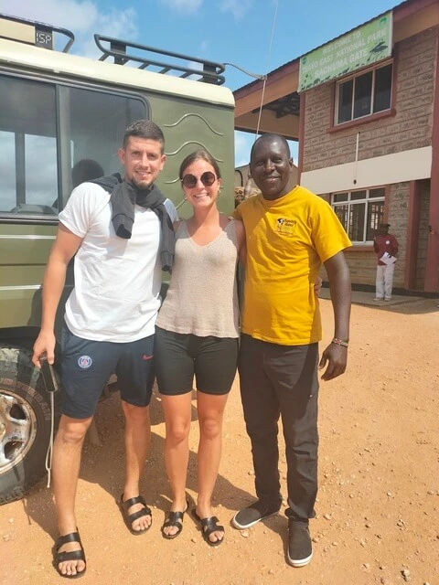 Sunday Best Safaris tour guide photo with Tsavo East visitors during 4 day Amboseli Tsavo Kenya Safari
