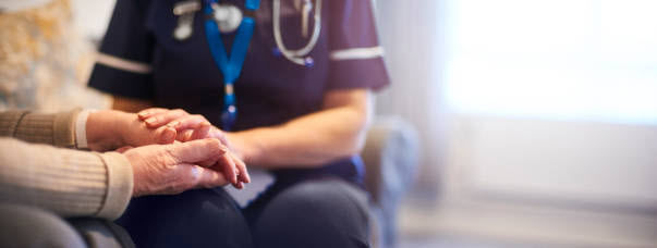 geriatric nurse assisting with COVID screening