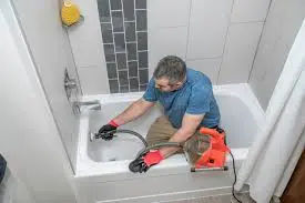 Caucasian male technician working indoors with PPE in industrial setting.