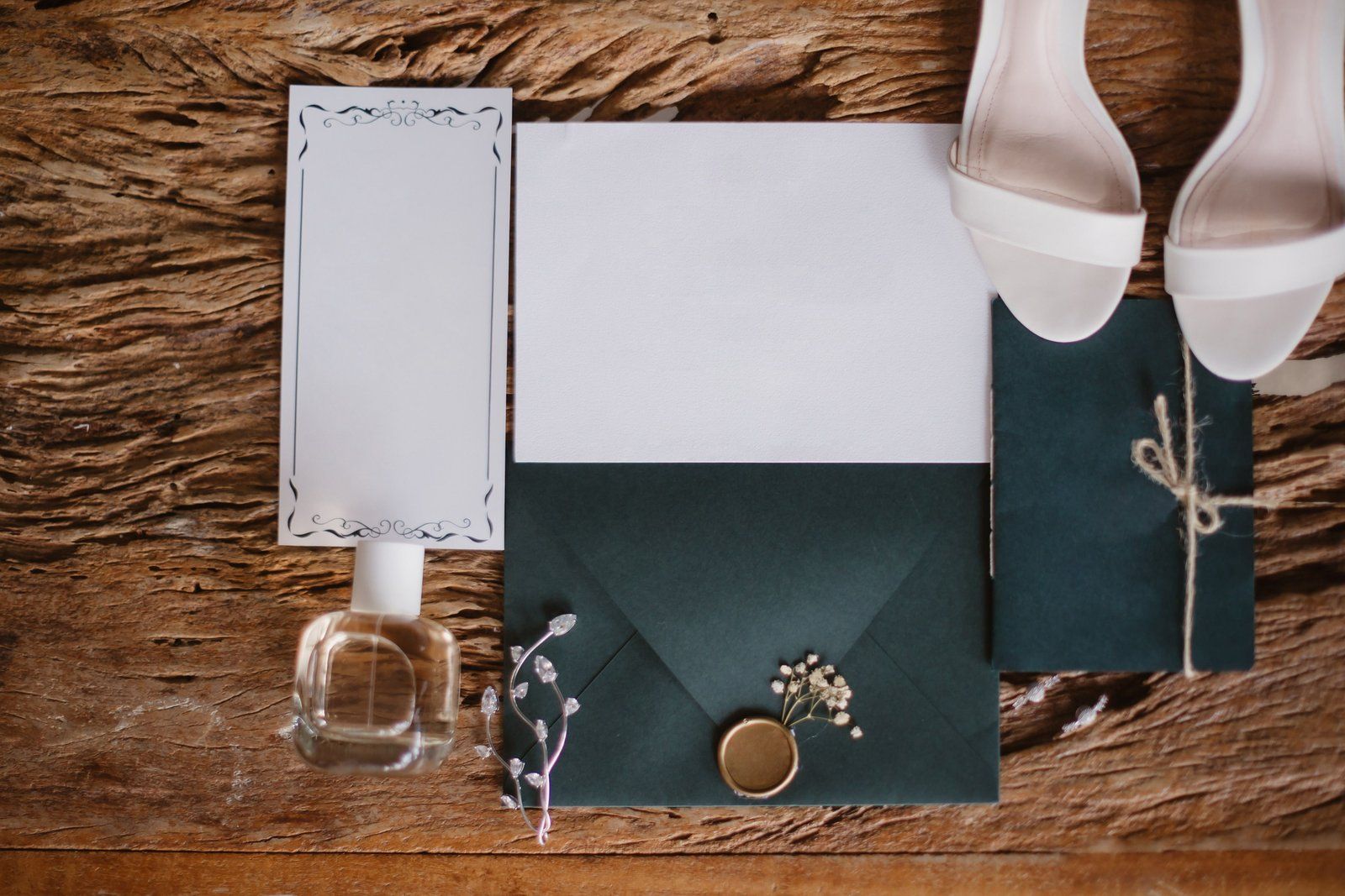 Wedding invitation and outer envelope laid flat with a wax seal and blank enclosure cards