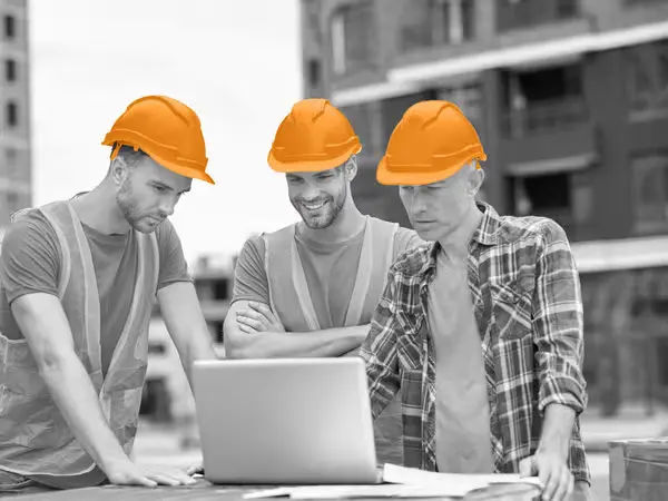 Field Service Management Team Using Software on Laptop