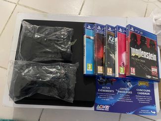 PlayStation 4, imported from England, with 2 controllers and 5 games