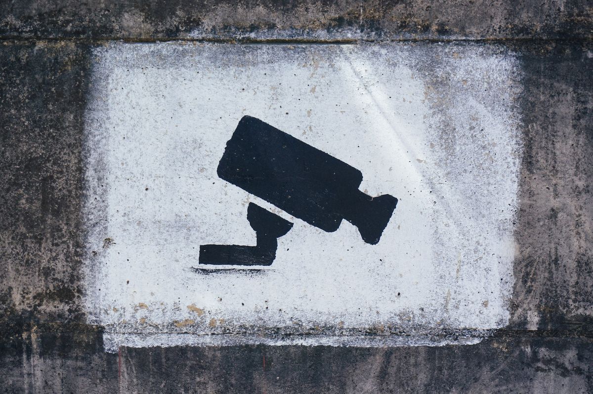 A painting on a wall warning visitors about video surveillance 