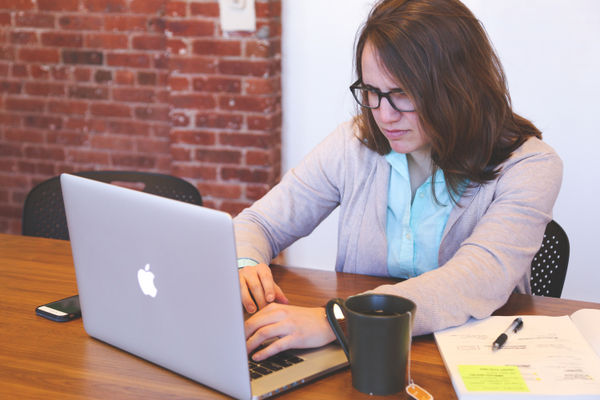 distracted, annoyed woman on computer 