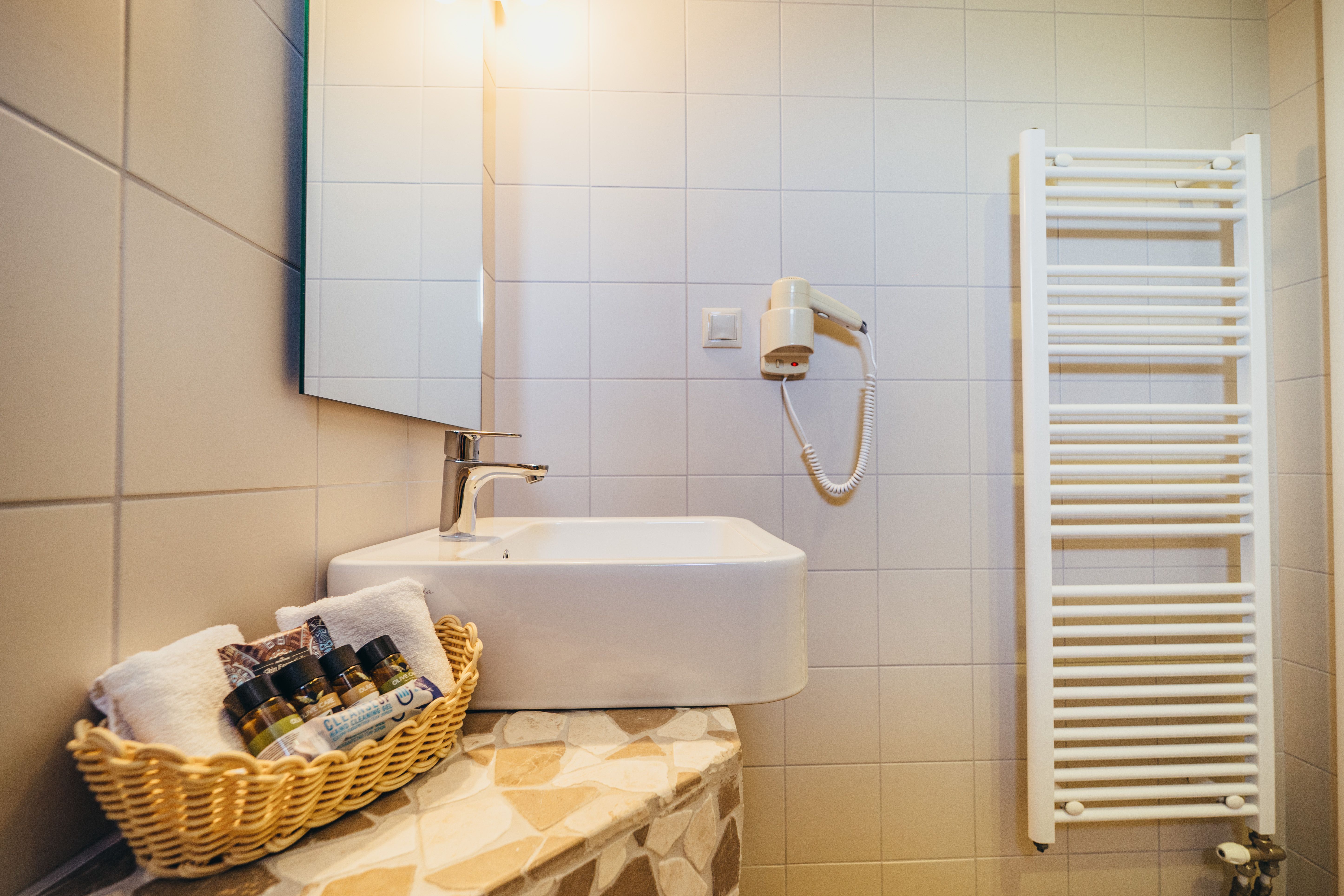 Bathroom sink with mirror and toiletries in budget room