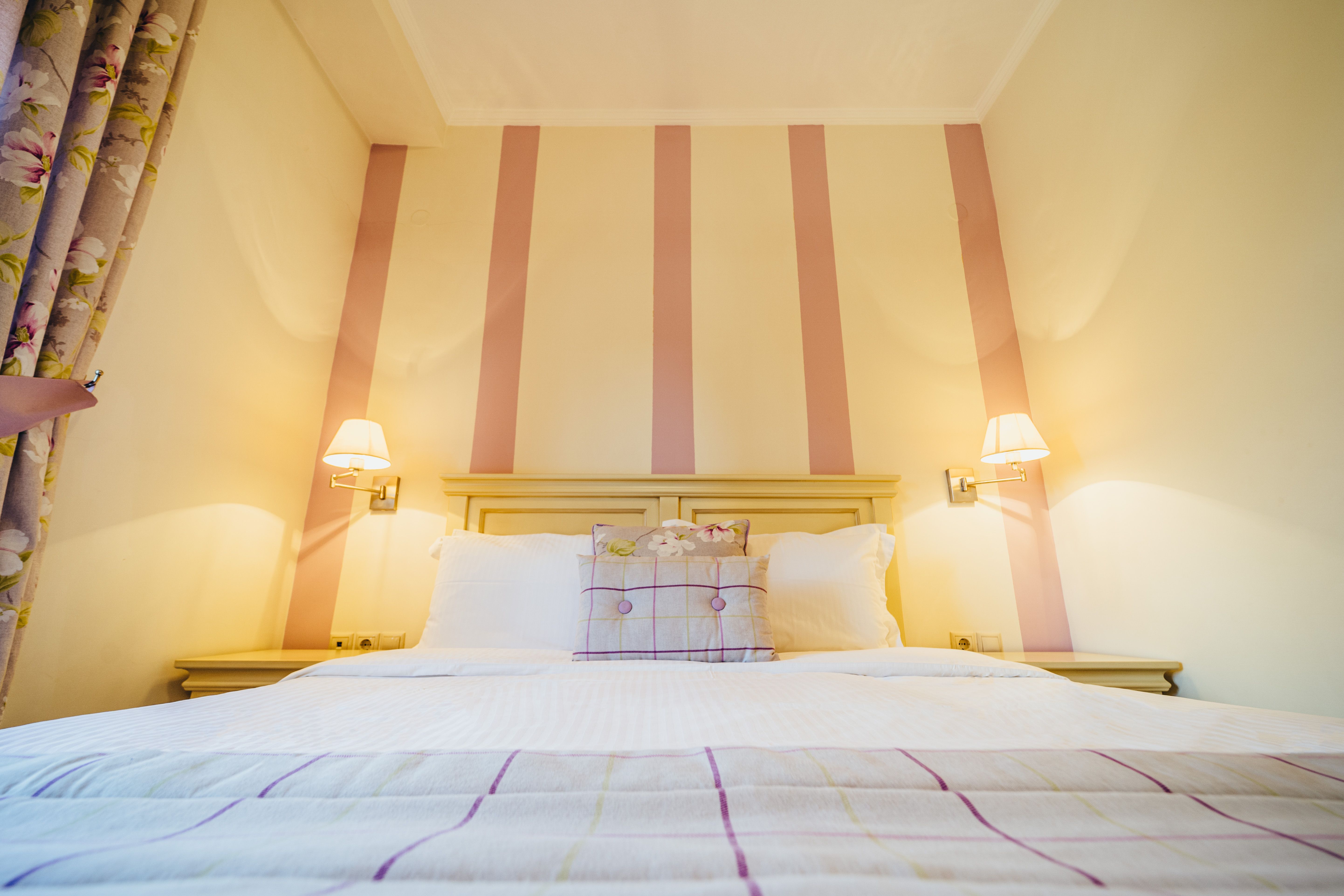 Bedroom interior of deluxe purple room with bedside lamps