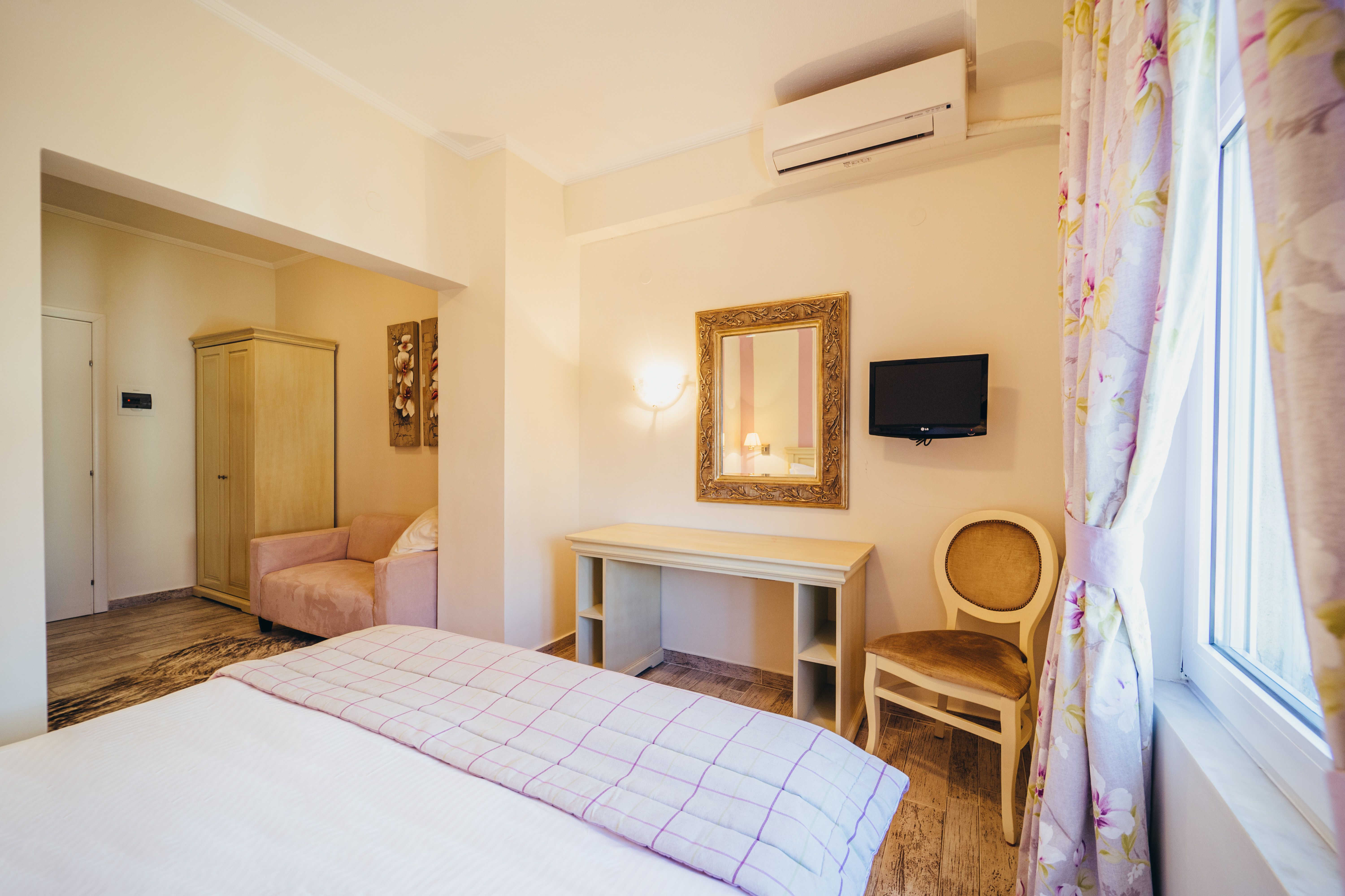 Deluxe purple room interior with double bed and work desk