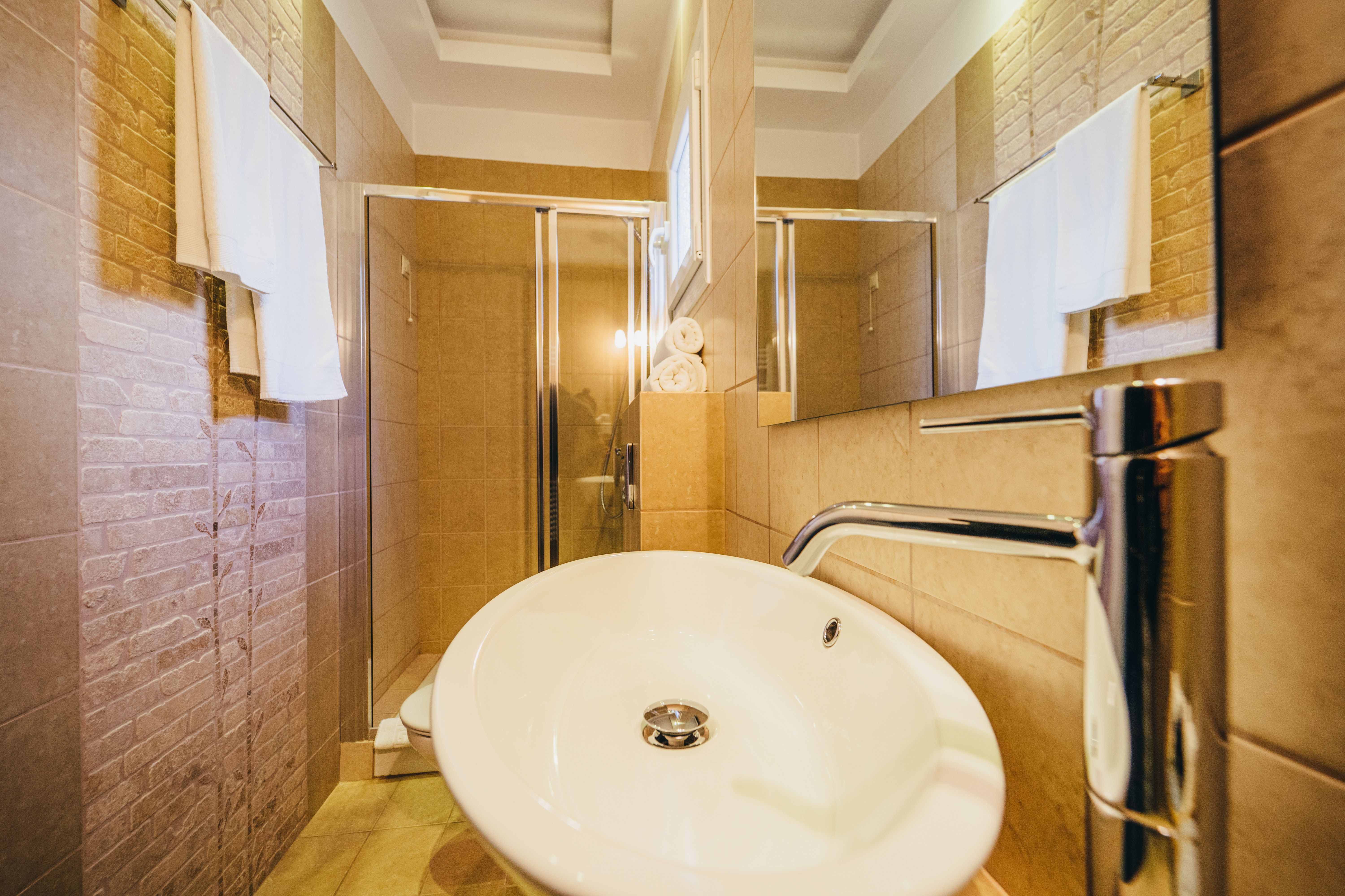 Private bathroom with sink and mirror in deluxe purple room
