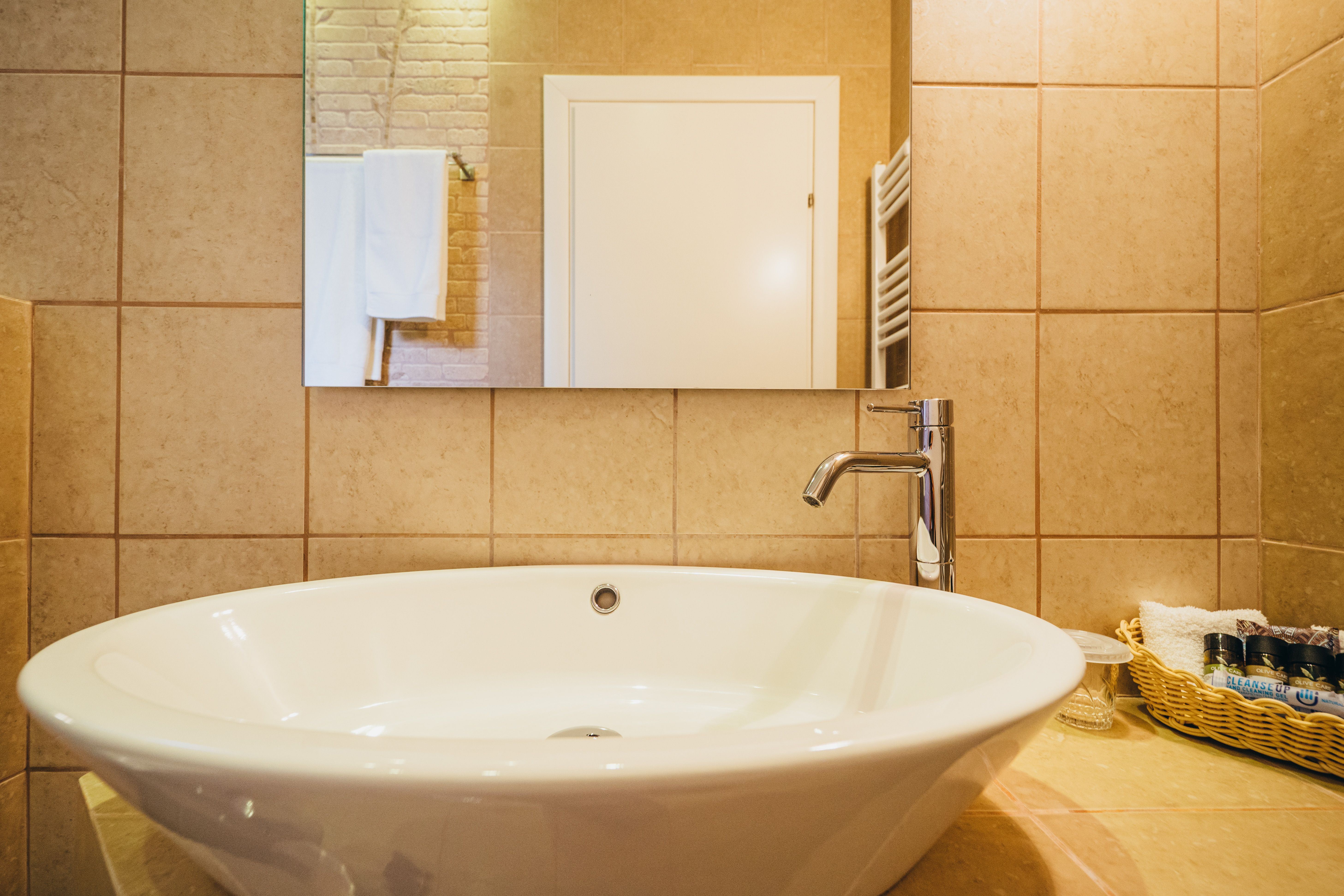 Bathroom sink with modern fixtures in deluxe purple room
