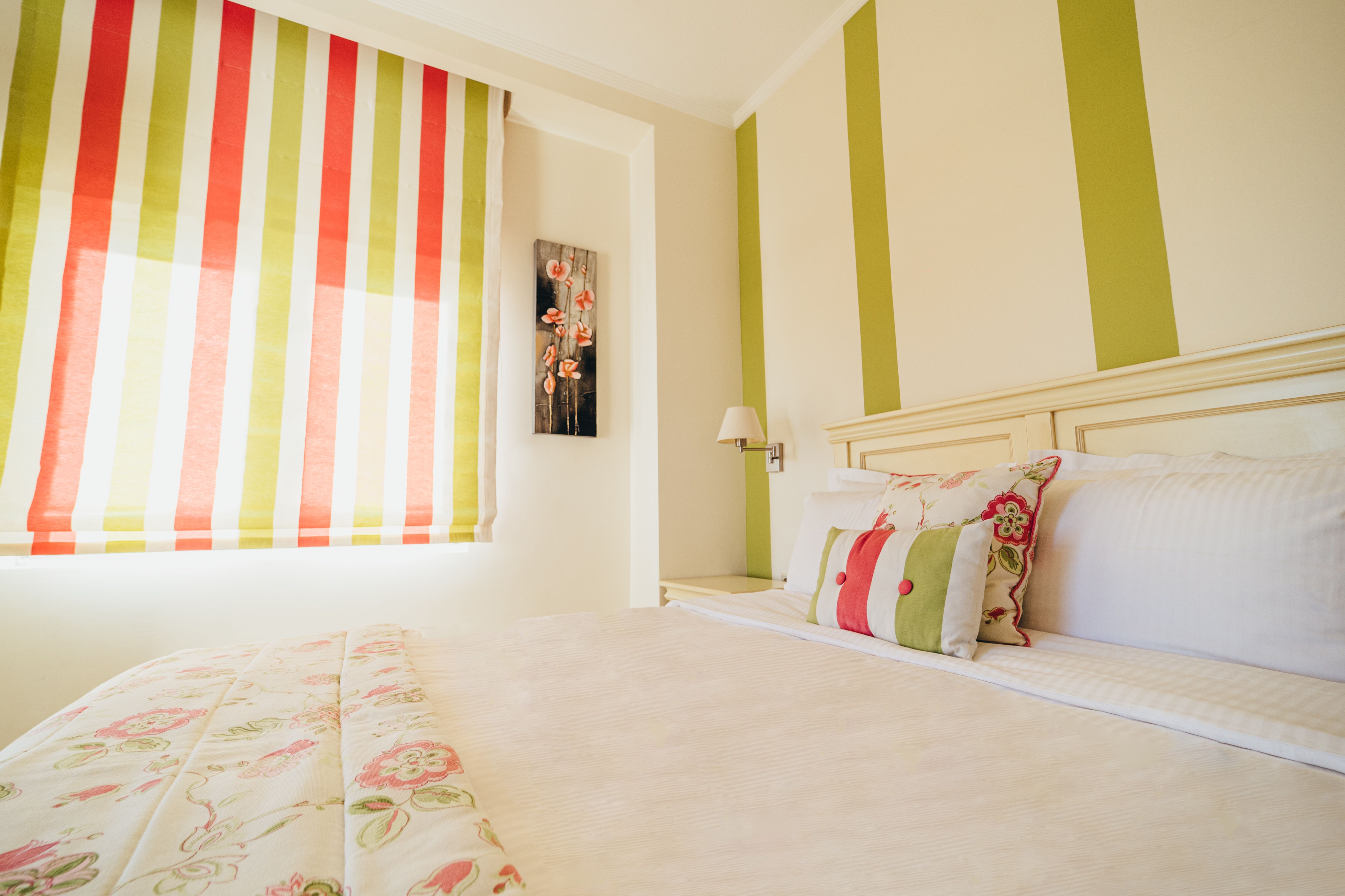 Double bed in standard room with striped wall decor