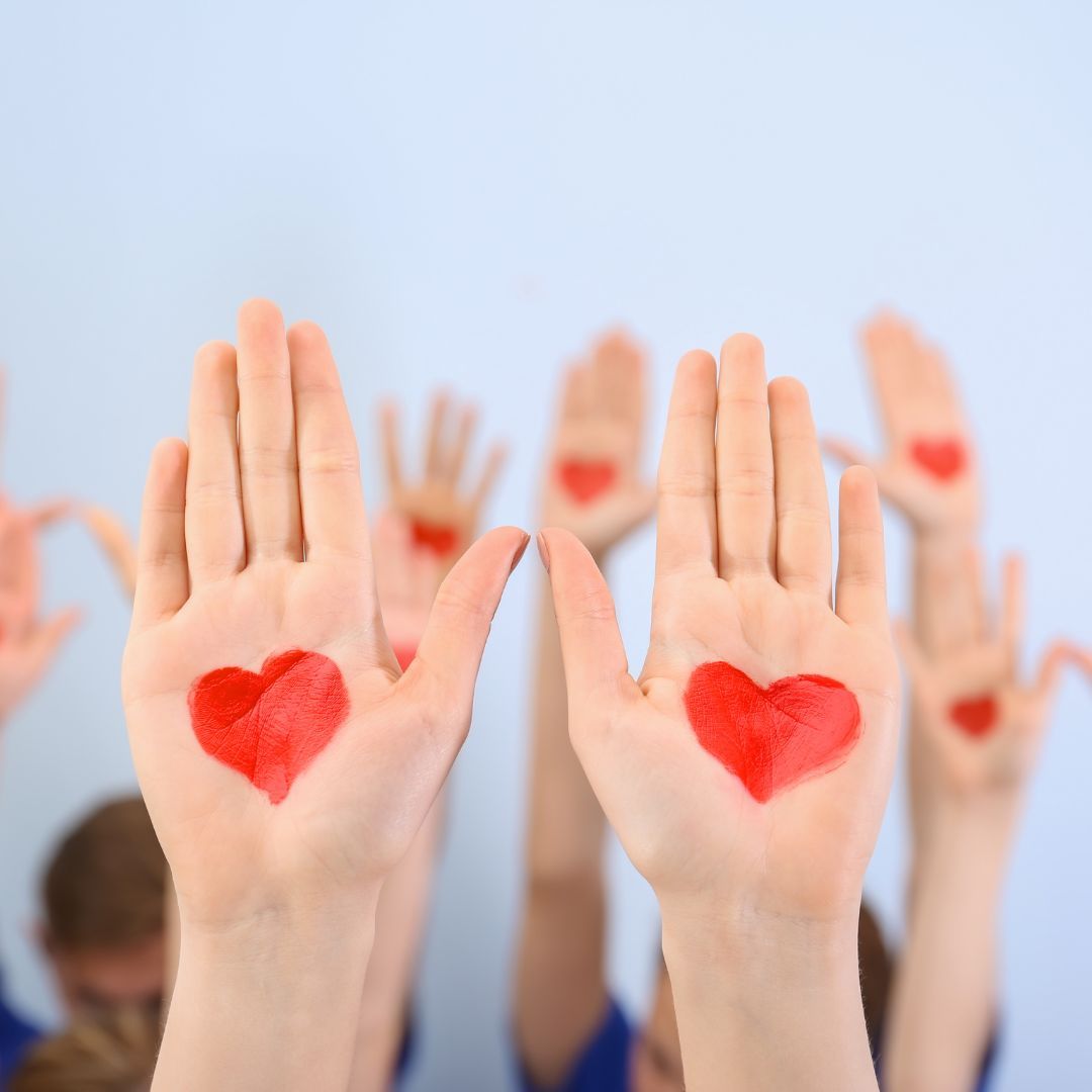 hands held up with hearts painted on