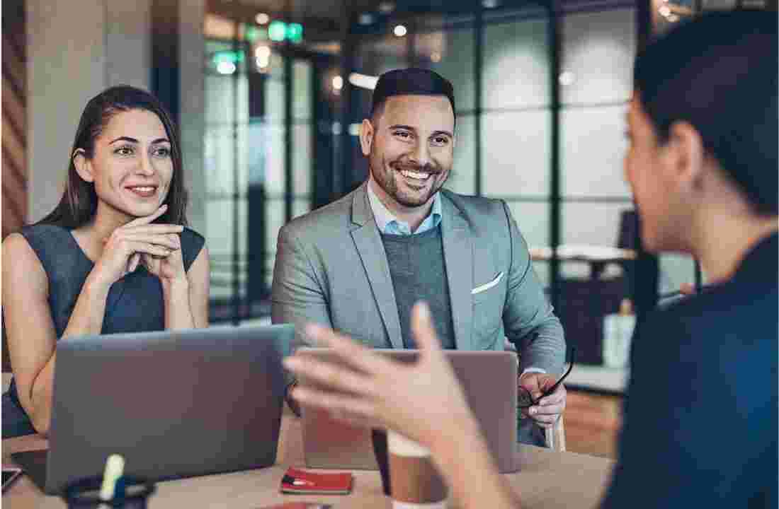 business people talking and smiling