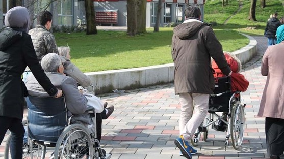 people pushing wheelchairs