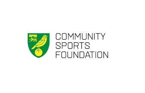 A green football badge showing a yellow canary beside the text Norwich City Community Sports Foundation