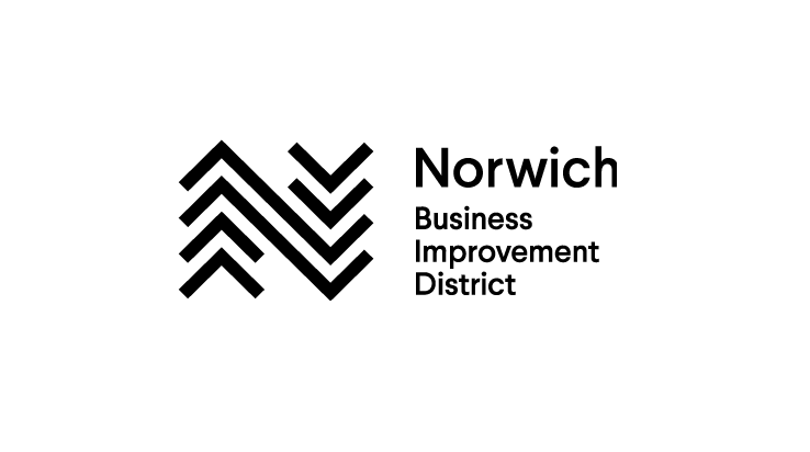 A logo with black chevrons and the text Norwich Business Improvement District