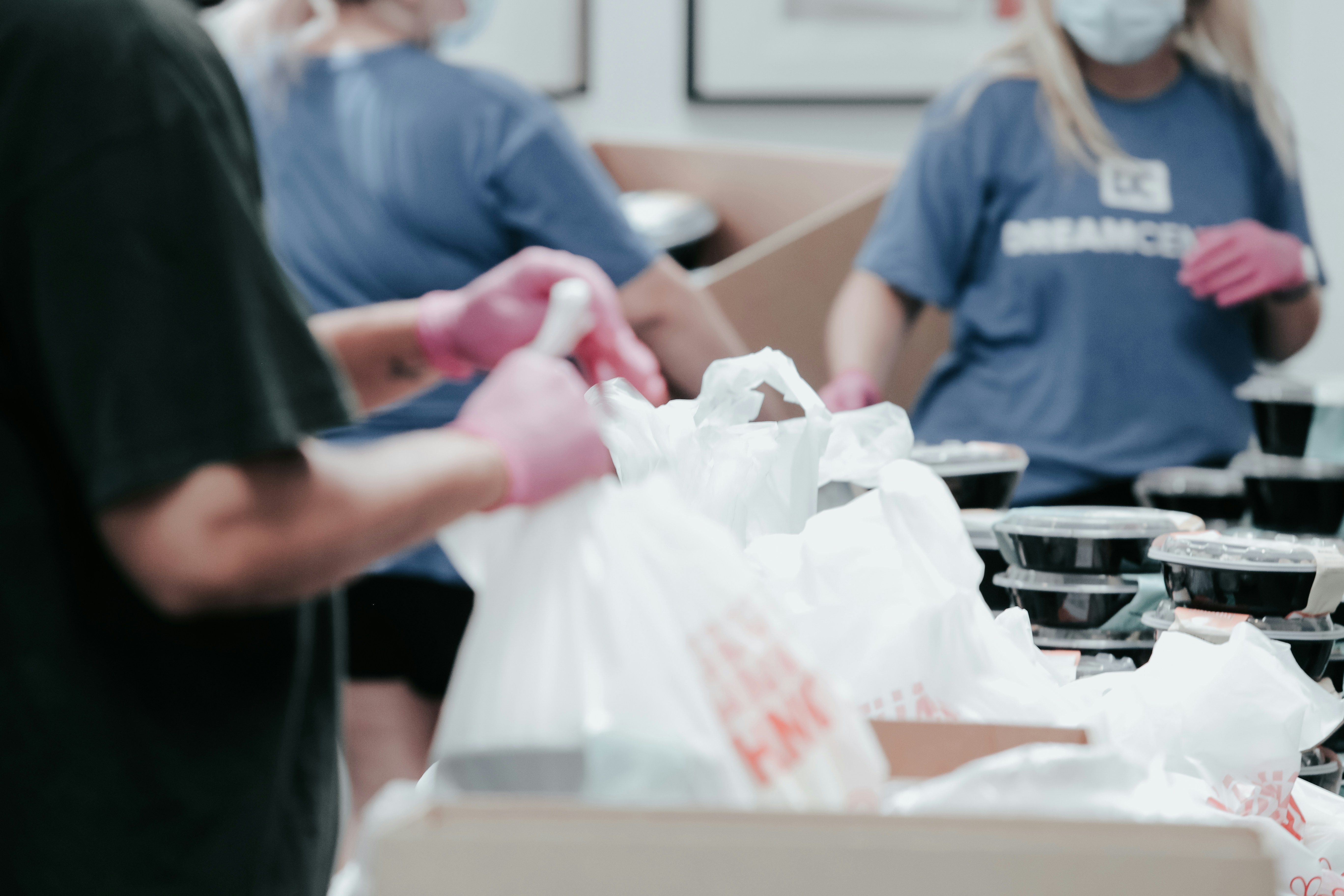 Volunteers helping to pack supplies in bag