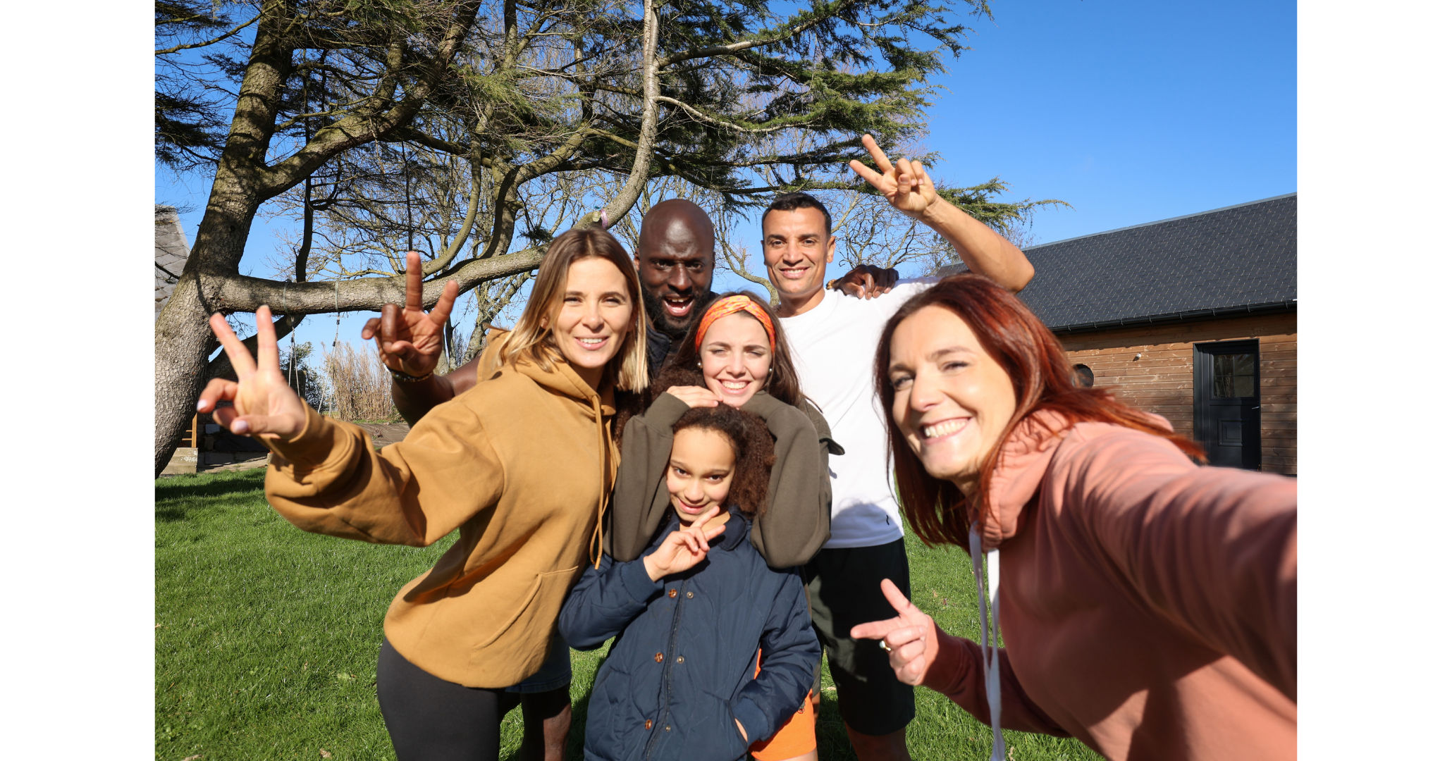 A Group of six friends gathered into a close group to take a selfie 