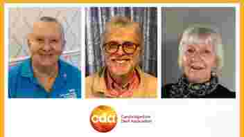 3 volunteers smiling to camera, Mary, Nick and Doris. Mary has short grey hair and is wearing a blue polo top. Nick has short grey hair and a beard and is wearing glasses. Doris has short great hair and is wearing a black top and scarf.