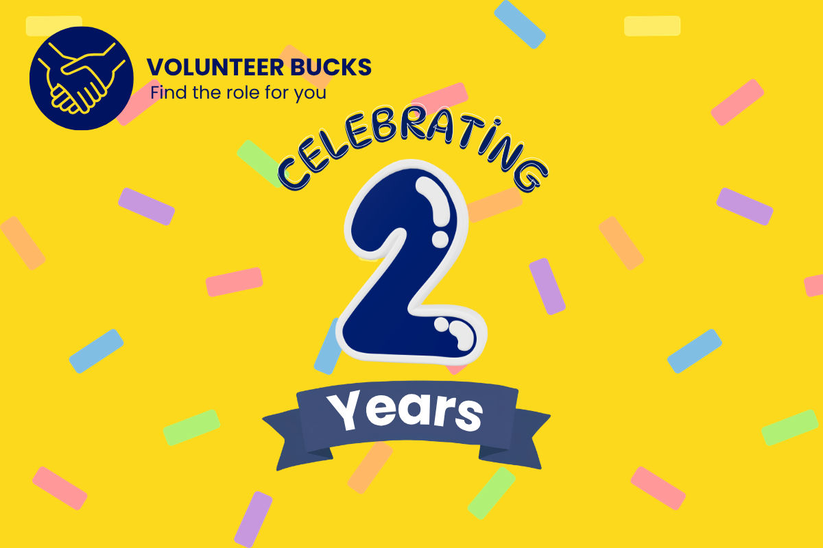 Celebrating two years written on confetti background, with Volunteer Bucks logo in top-left corner