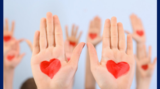 Raised hands with hearts painted on palms