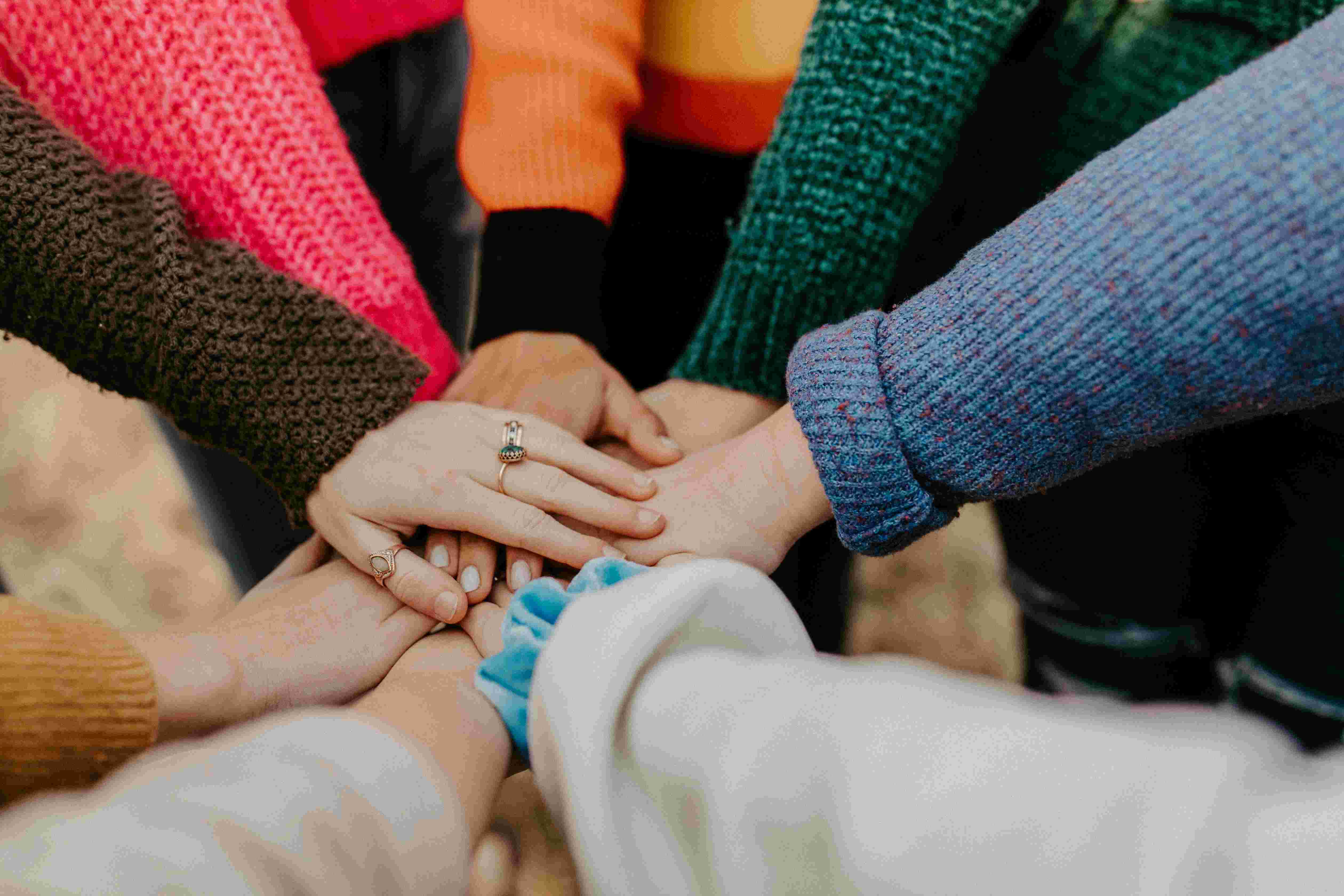 hands joined together in centre of circle